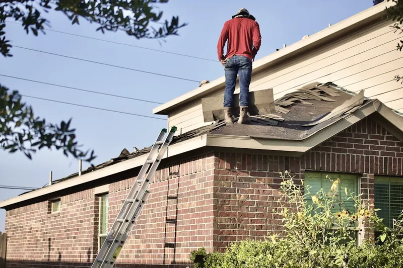 Professional roofer working on a residential roof in Laurens